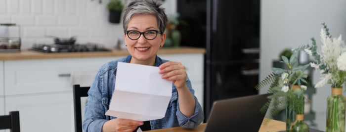 Woman smiling and looking at her energy rebate